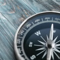 Brass antique compass  on background