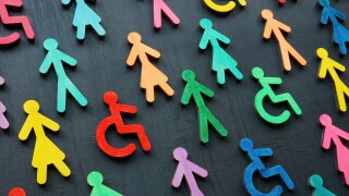 Diversity and inclusion concept. Colorful figurines on the dark surface.