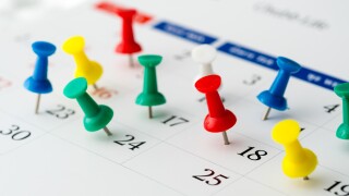 Push pins on calendar. Idea concept of to do planning.