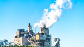 Industrial paper mill factory plant with chimney smokestacks sta