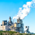 Industrial paper mill factory plant with chimney smokestacks sta