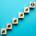 Us dollar growth concept and with icons on wooden blocks.