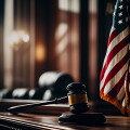 Mallet of judge in American courtroom. American flag in courtroo