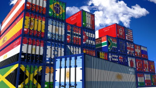 Shipping containers in the colours of different national flags, with Argentina's at the front
