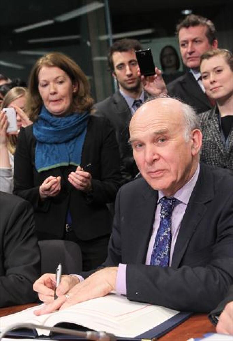 UK's Vince Cable signs