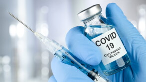 Healthcare cure concept with a hand in blue medical gloves holdi