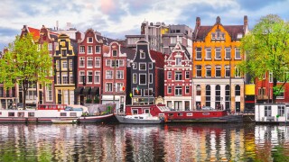 Amsterdam Netherlands dancing houses over river Amstel landmark