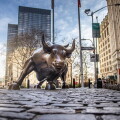 NEW YORK CITY - MARCH 24, 2020: Charging Bull sculpture on March 24, 2020 on empty streets of  New York City during Corona virus Epidemic. 
