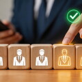 Businessman choosing best candidate from wooden blocks with glowing checkmark recruitment concept digital selection HR management hiring process professional decision making