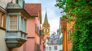 Beautiful cozy street and tower of Saint Peter church in the city center of Zurich, Switzerland