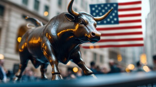 Close-up of the Bull statue on with the American flag in the background. Iconic symbol of financial strength and optimism in a bustling city environment.